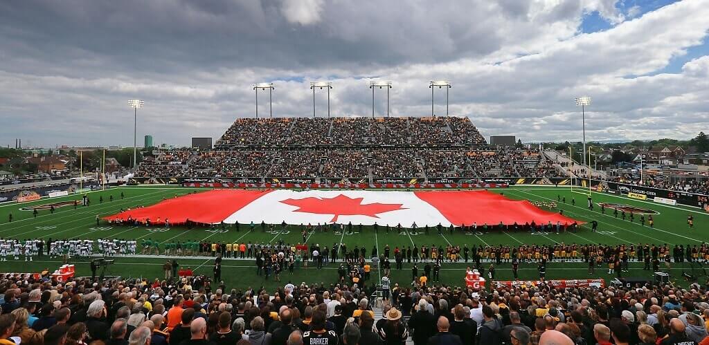 A Canadian flag proudly displayed across the stadium field